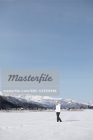 Young woman standing in snow