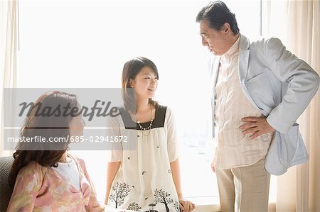 Parents and daughter talking