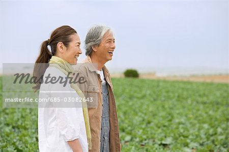 Senior couple standing in field