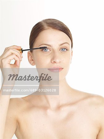 Woman is brushing her lashs