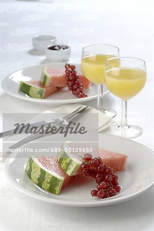 Place setting with melon,red currant and juice