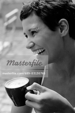 Laughing woman with cappuccino cup