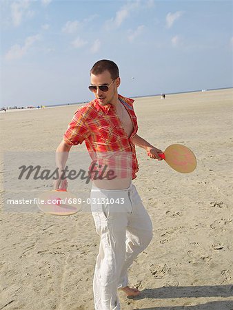 Young playing beachball