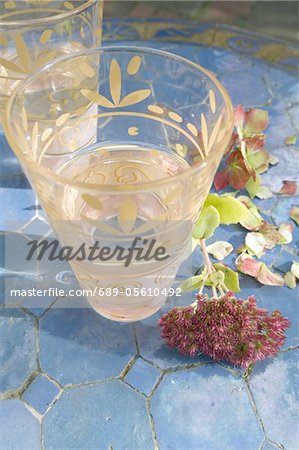 Ornate glass of water on blue tiles