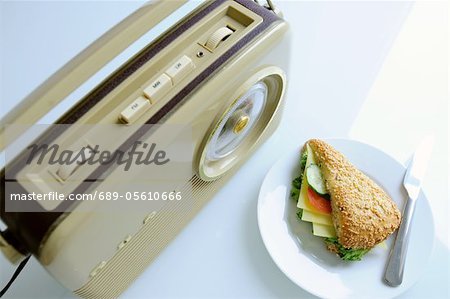 Old-fashioned radio and sandwich