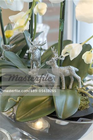 Deer figurines in potted plant