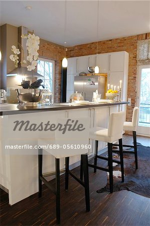 Modern open plan kitchen with bar stools