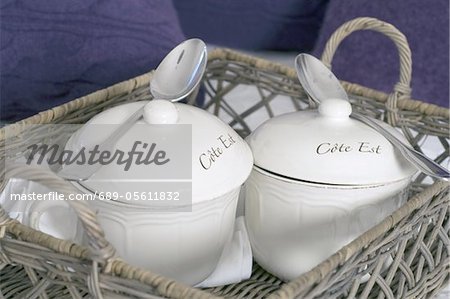 Two porcelain receptacles with spoons