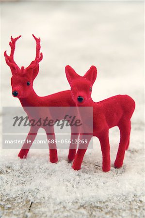 Two red deer figurines in fake snow