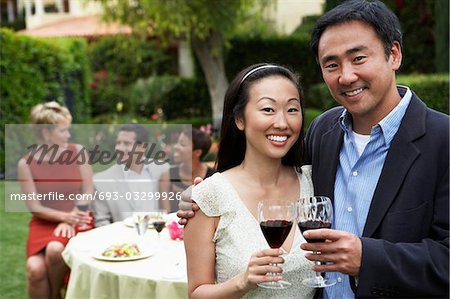 Couple drinking wine at garden party