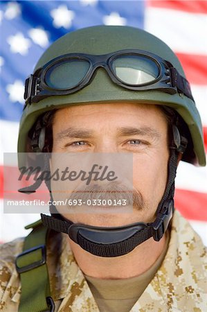 Soldier with moustache in front of United States flag, (close-up), (portrait)