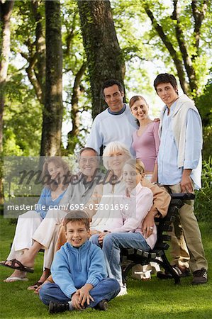 Family posing for portrait in back yard, portrait