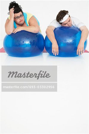 Overweight Man and Woman with Exercise Balls
