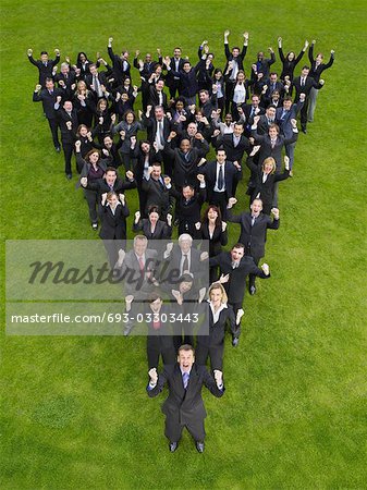 Large group of business people standing in triangle formation, cheering, elevated view