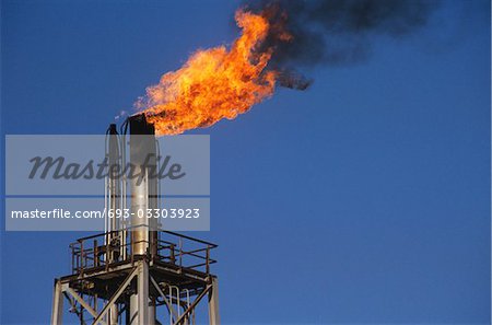 flames rising out of smoke stack