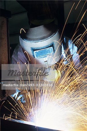 Welder wearing protective face mask welding at Work