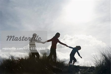 family of 5 holding hands silhouette