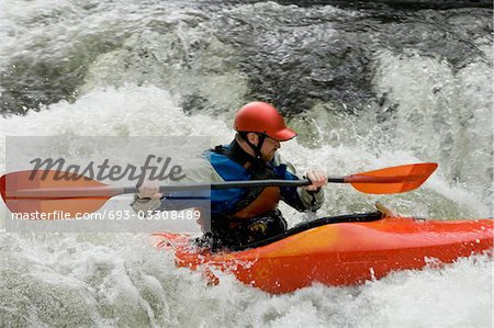 Man kayaking in river