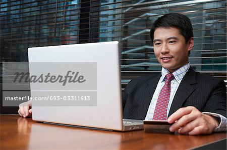 Business man using laptop in cafe