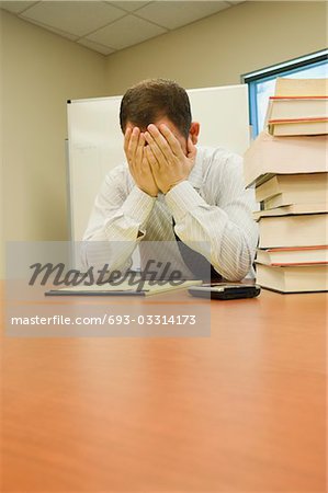Stressed Businessman with Head in hands