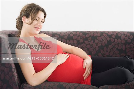 Pregnant woman relaxing on sofa