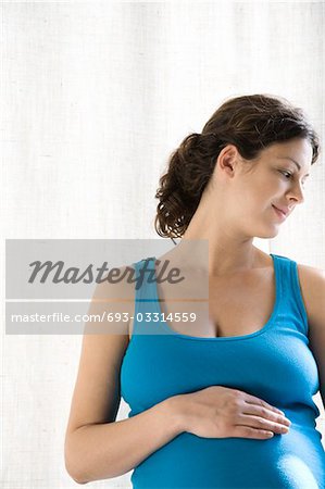 Pregnant woman holding stomach