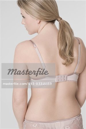 Young woman wearing bra, rear view - Stock Photo - Masterfile