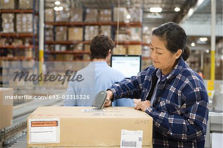 Woman and man working in distribution warehouse