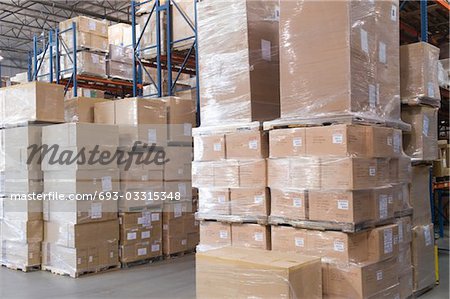 Cardboard boxes stacked in distribution warehouse