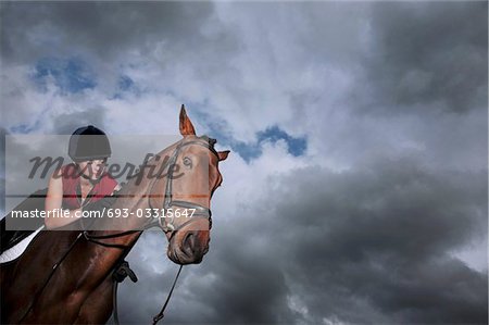 Female jockey riding horse