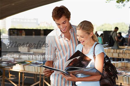 Young couple looking at book in inner-city book market