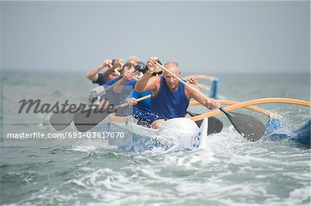 Outrigger canoeing team on water