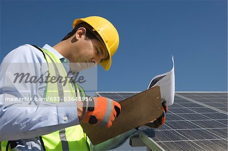 Maintenance worker with photovoltaic array in Los Angeles, California