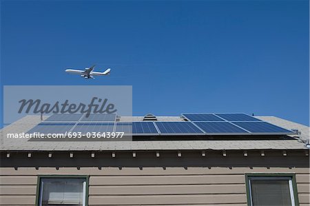 Aeroplane and rooftop with solar array, Inglewood, Los Angeles, California