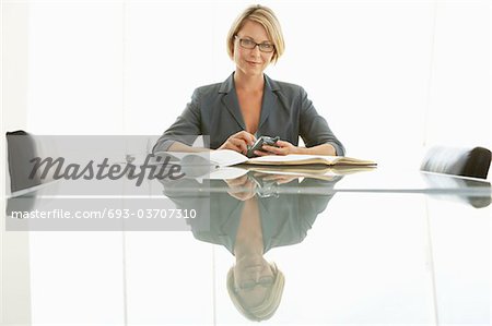 Businesswoman at conference table, portrait