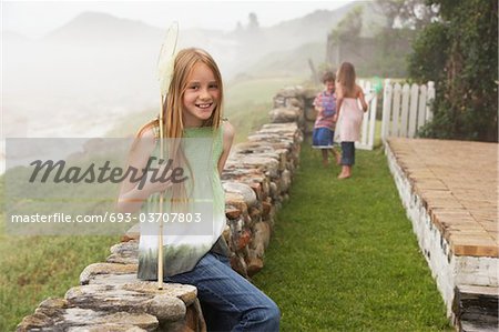 Girl with Butterfly Net in Garden