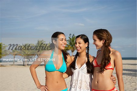 Three teenage girls (16-17) wearing bikinis, standing on beach, portrait -  Stock Photo - Masterfile - Premium Royalty-Free, Code: 693-03707944