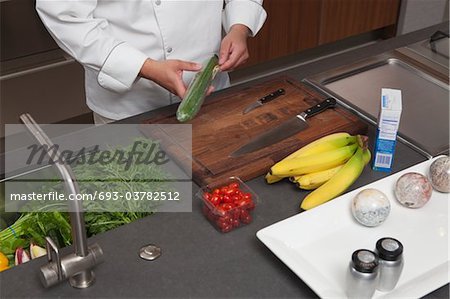 Mid- adult chef prepares fresh food