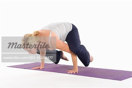 Mature woman balancing on her hands