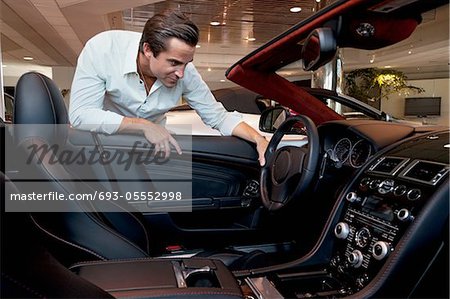 Man checking out his new car