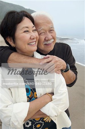 Mature couple embracing at beach