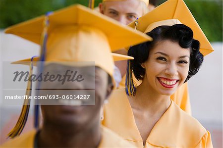 Graduates In Line For Degree Outside Focus On Woman Stock Photo