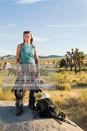 Climber standing on Boulder with Gear, (portrait)