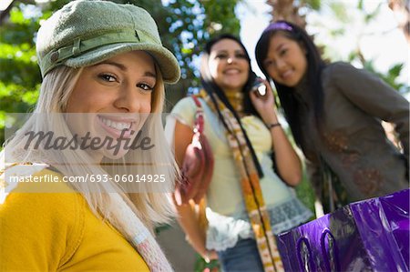 Teenage girls (16-17) smiling, outdoors, (portrait)