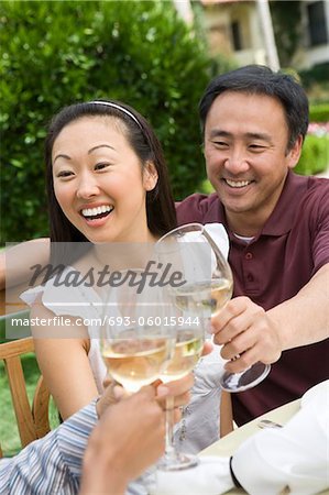 Couple toasting with friends outdoors