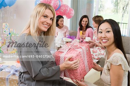 Woman Receiving a Gift at a Baby Shower