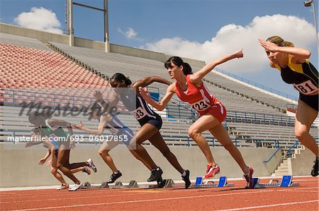 Group of female track athletes sprinting
