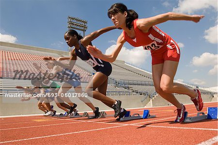 Group of female track athletes sprinting