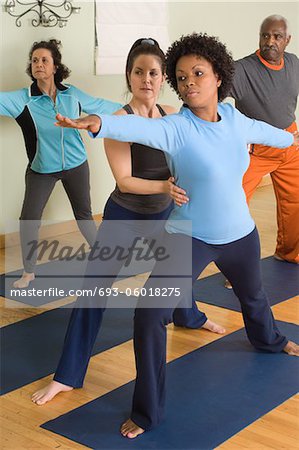 Yoga Instructor Assisting Woman in Yoga Class
