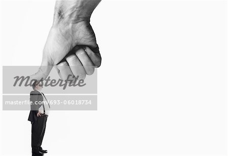 Office worker being bushed by large thumb